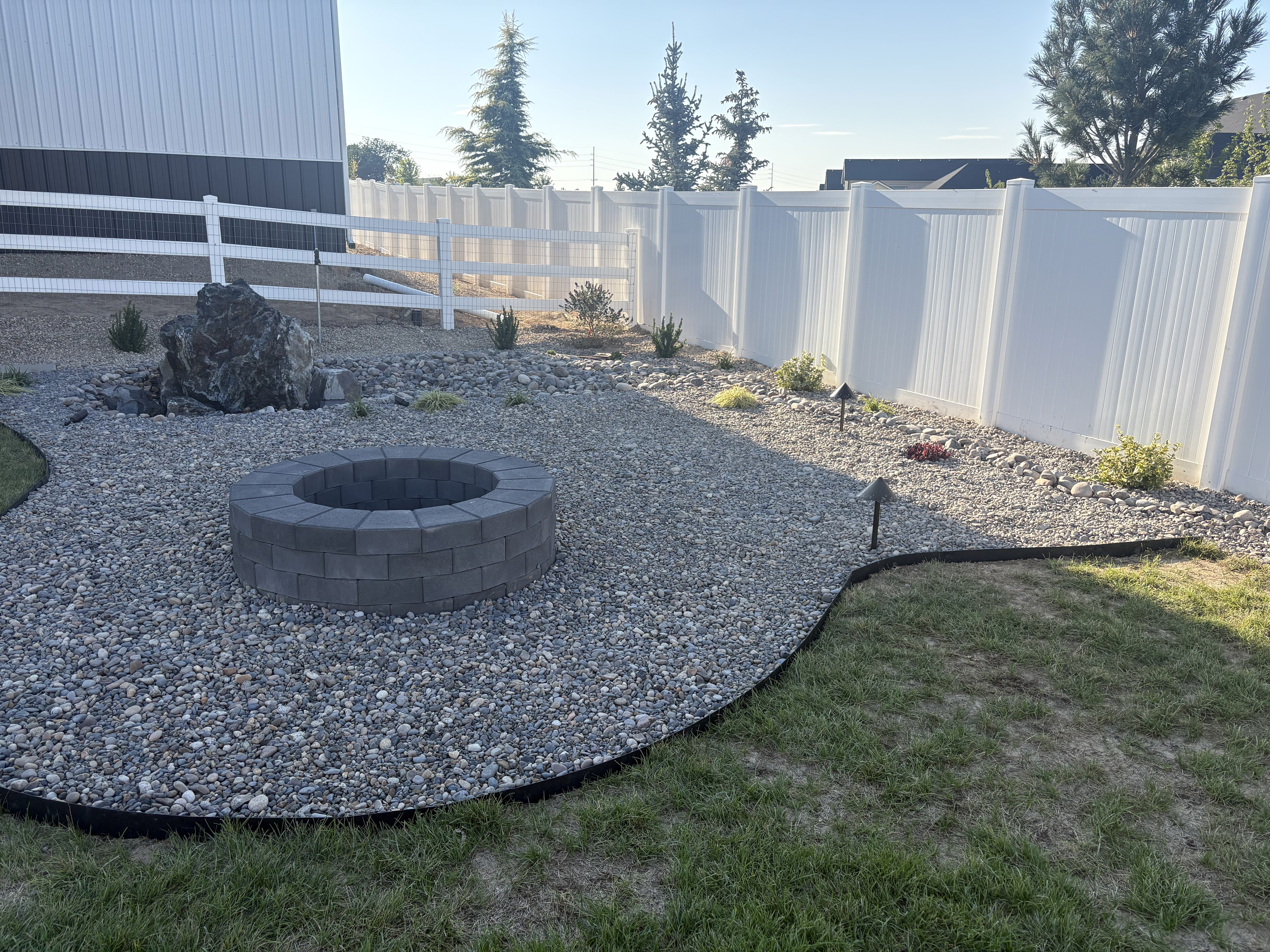 Project 04 completed fire pit and rock patio with boulder water feature