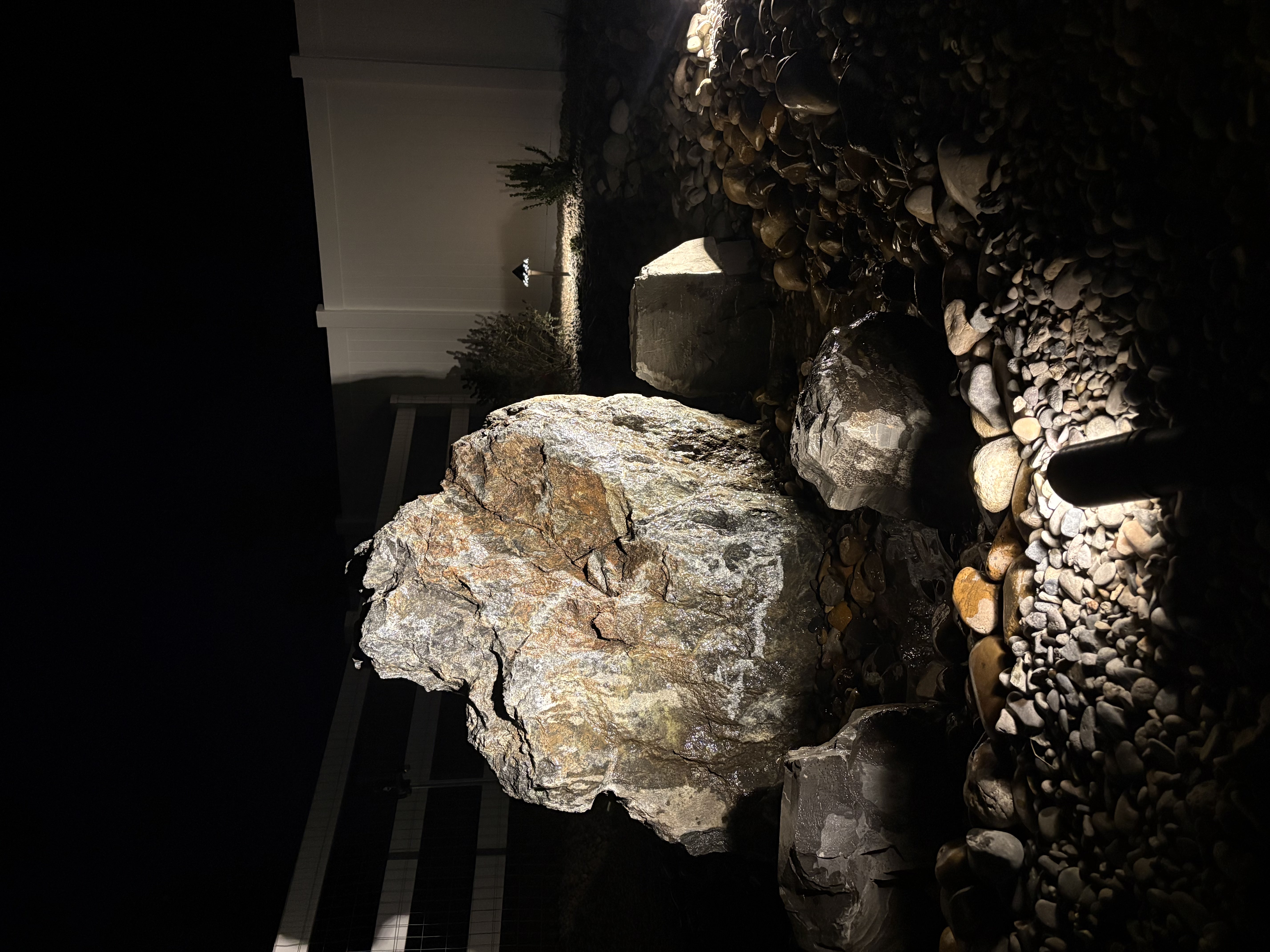 Project 04 completed boulder water feature illuminated at night